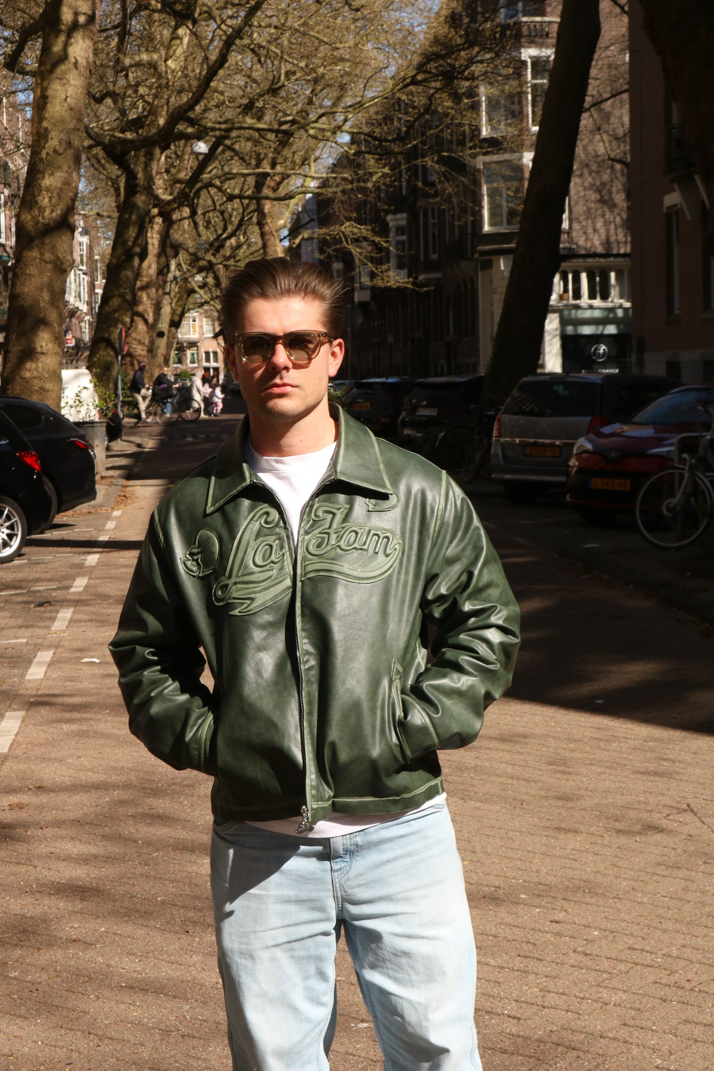 Man posing in Amsterdam streets wearing Glace Eyewear sunglasses, model Olive MOKUM