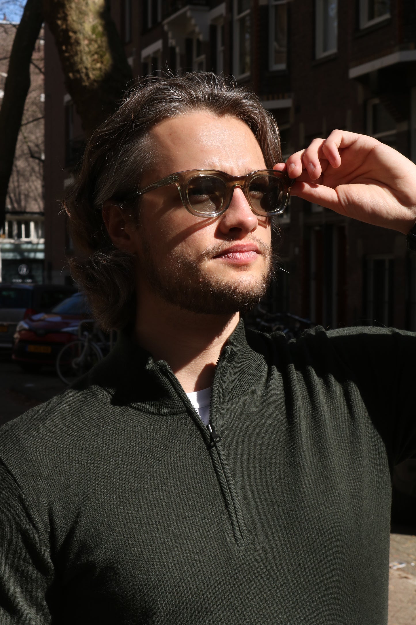 Man posing in Amsterdam streets wearing Glace Eyewear sunglasses, model Olive MOKUM