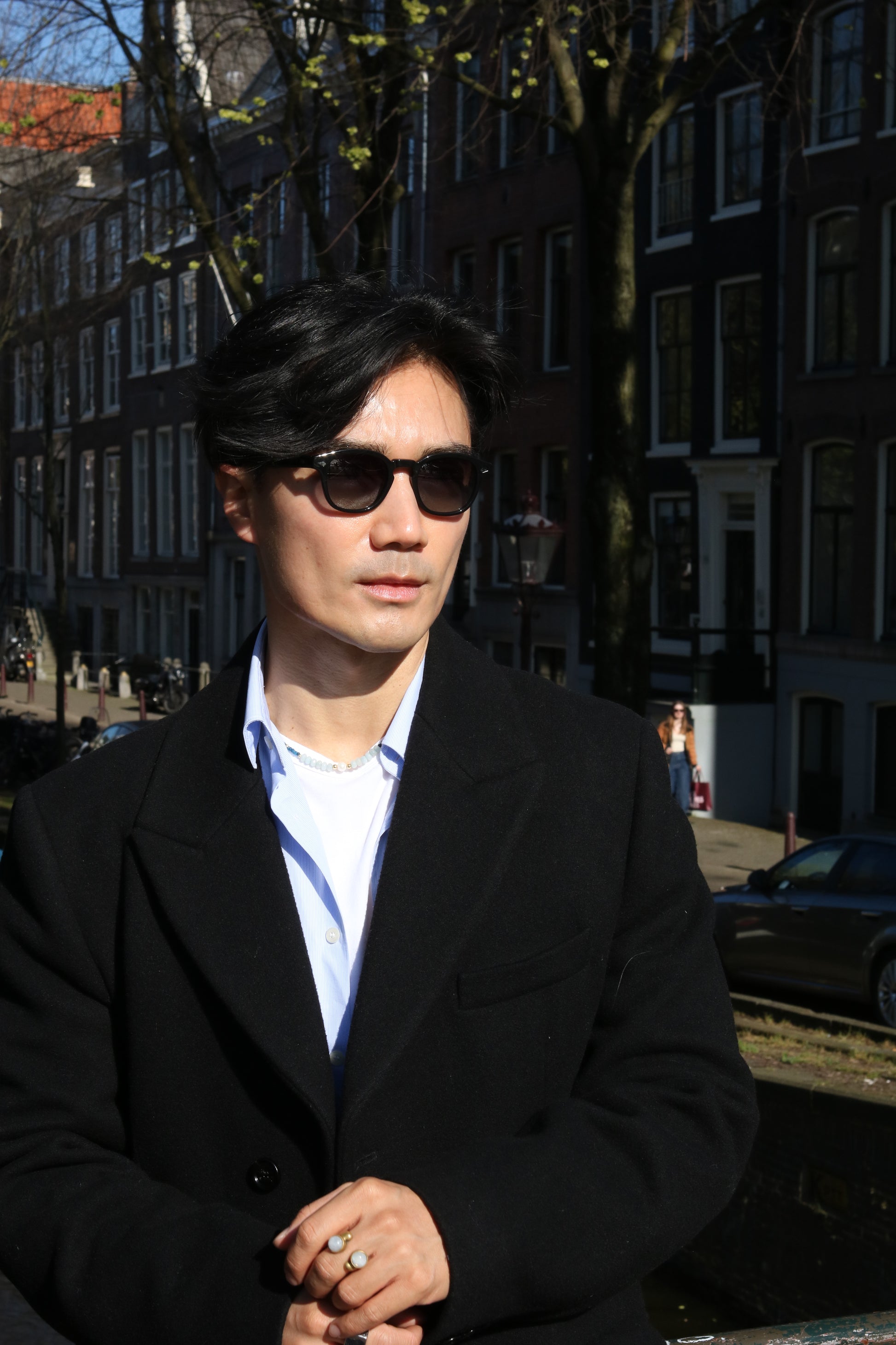 Man posing in Amsterdam streets wearing Glace Eyewear sunglasses, model Black CANNES.