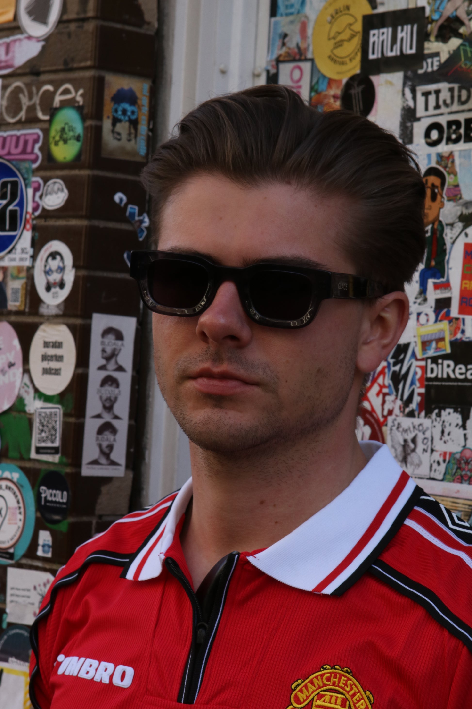 Man posing in Amsterdam streets wearing Glace Eyewear sunglasses, model Silver BERLIN.